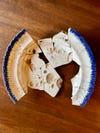 Old pieces of pottery put together like a plate