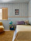 kids room with blue paint and wallpaper