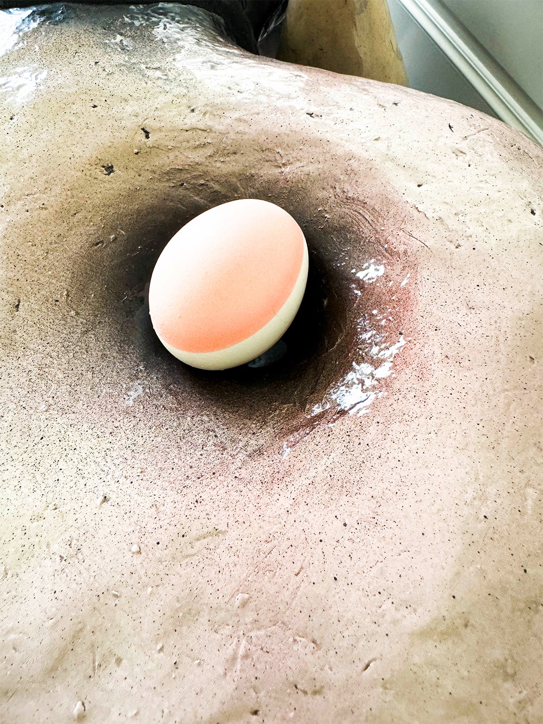 Easter egg hidden in a divot of a bench