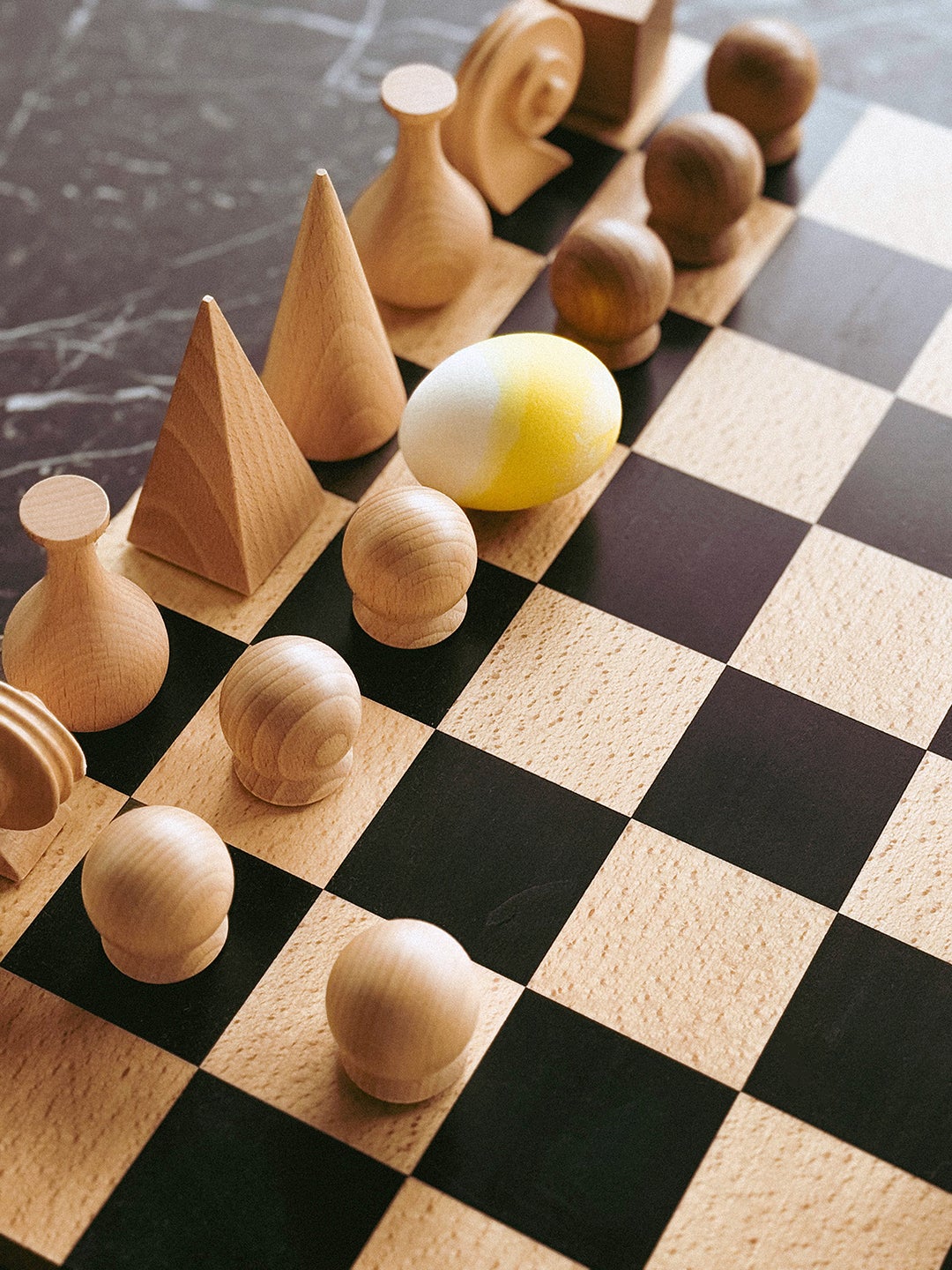 Easter egg as a chess piece on a chess board