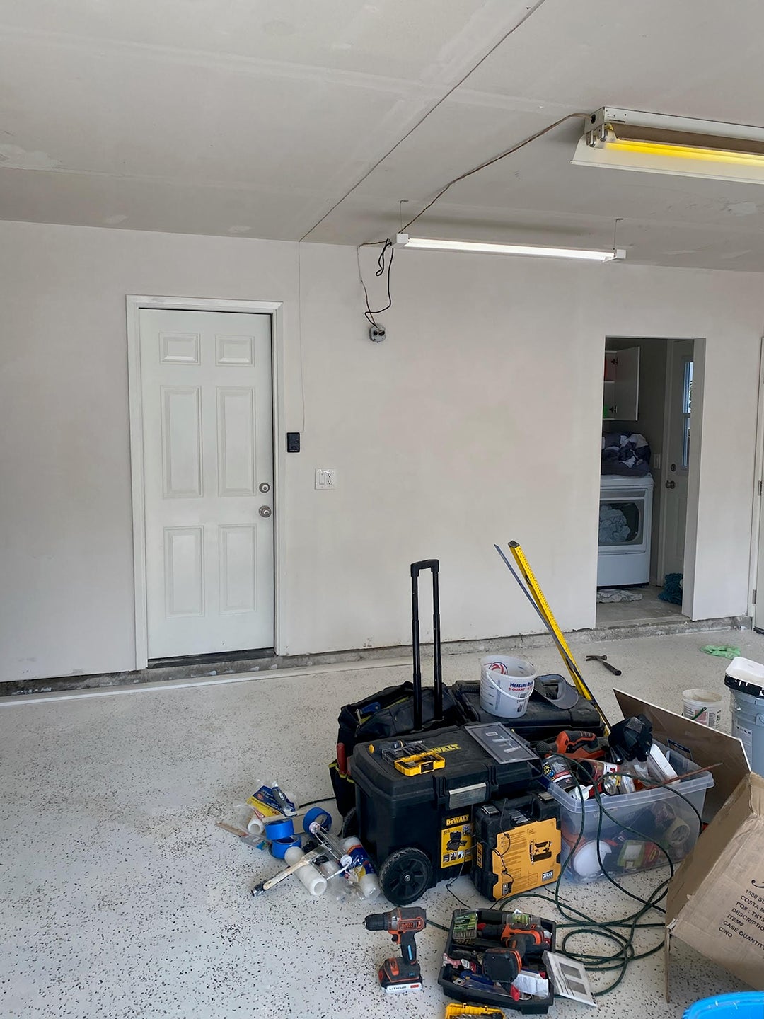 Unfinished white garage with tools