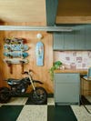 Motorbike parked in a garage and skateboards hanging above