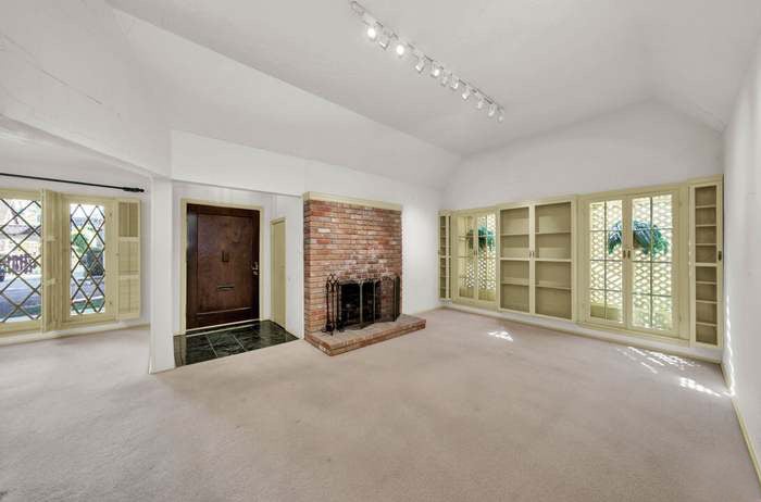 brick fireplace in carpeted room