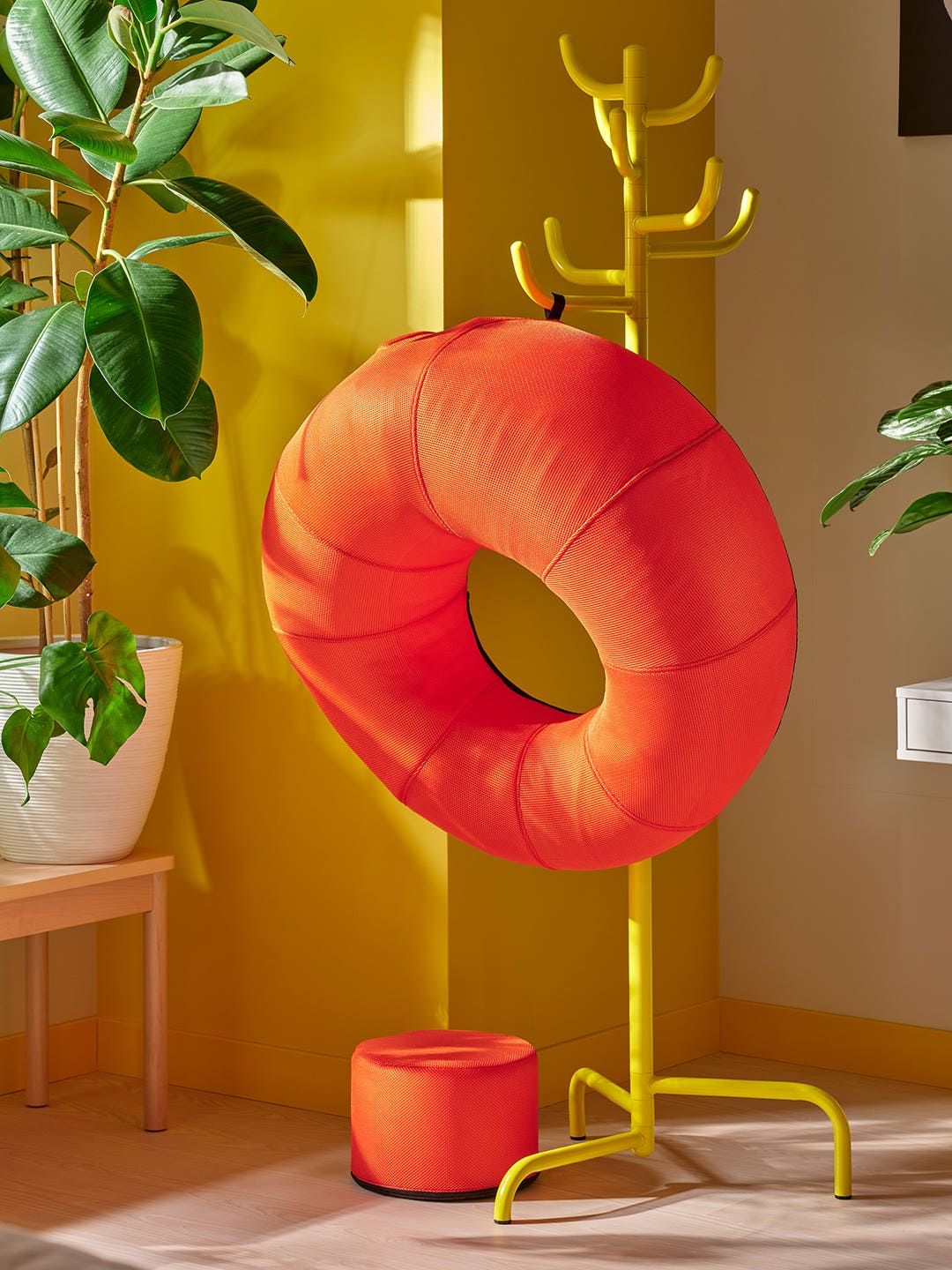 orange inflatable donut chair hanging from a coatrack