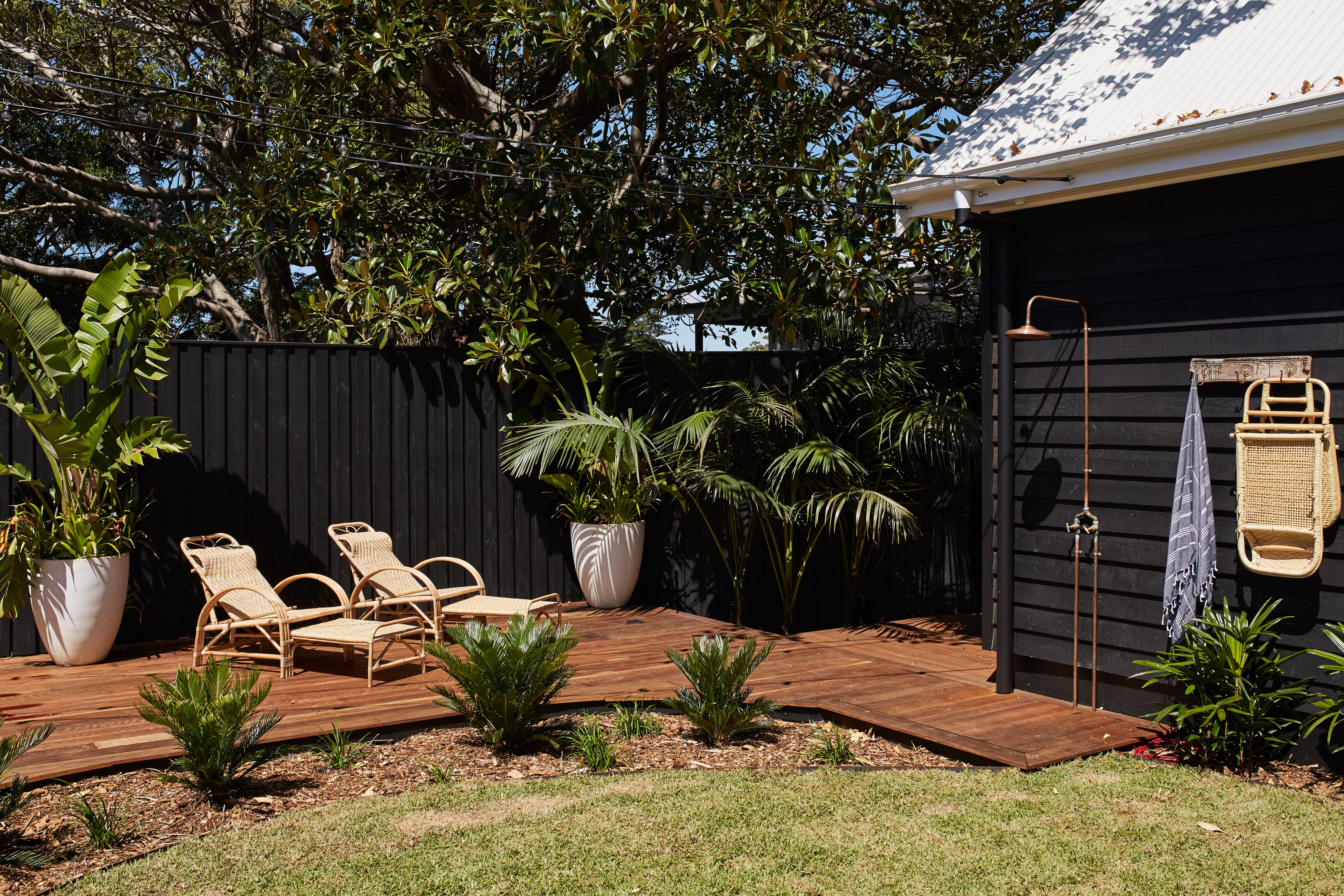 black house exterior with outdoor shower