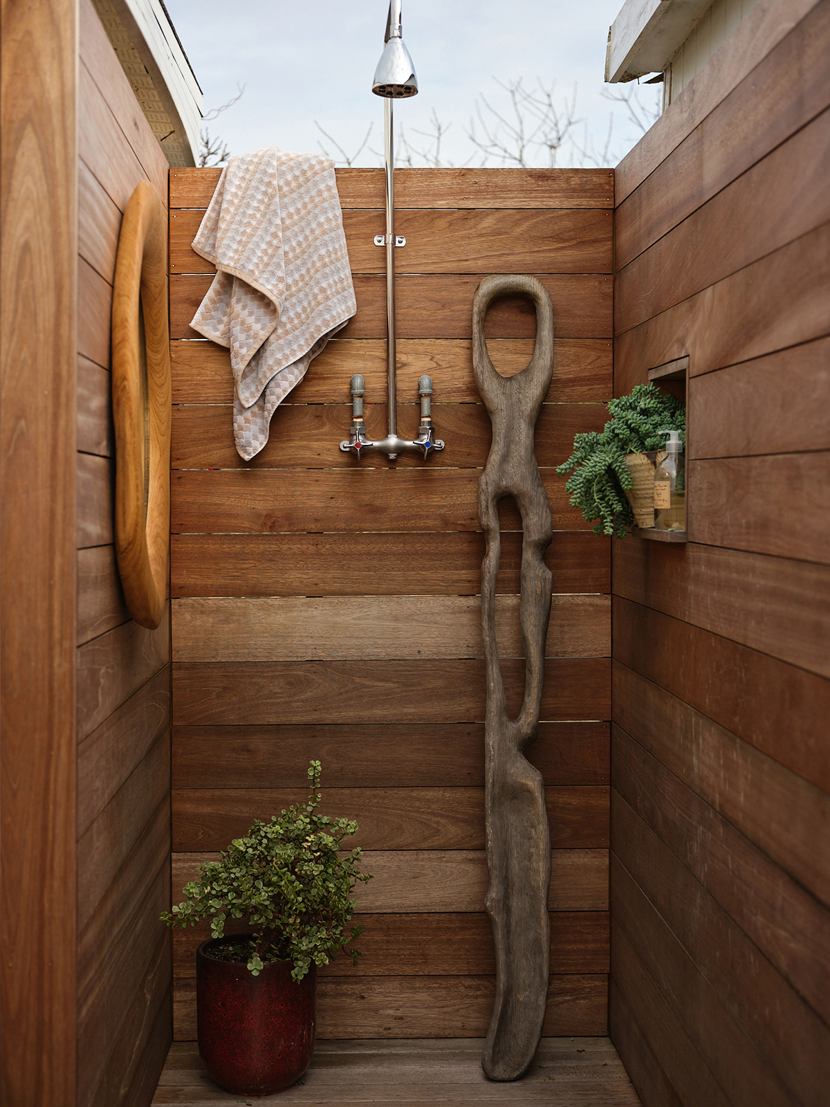 driftwood sculpture in outdoor shower