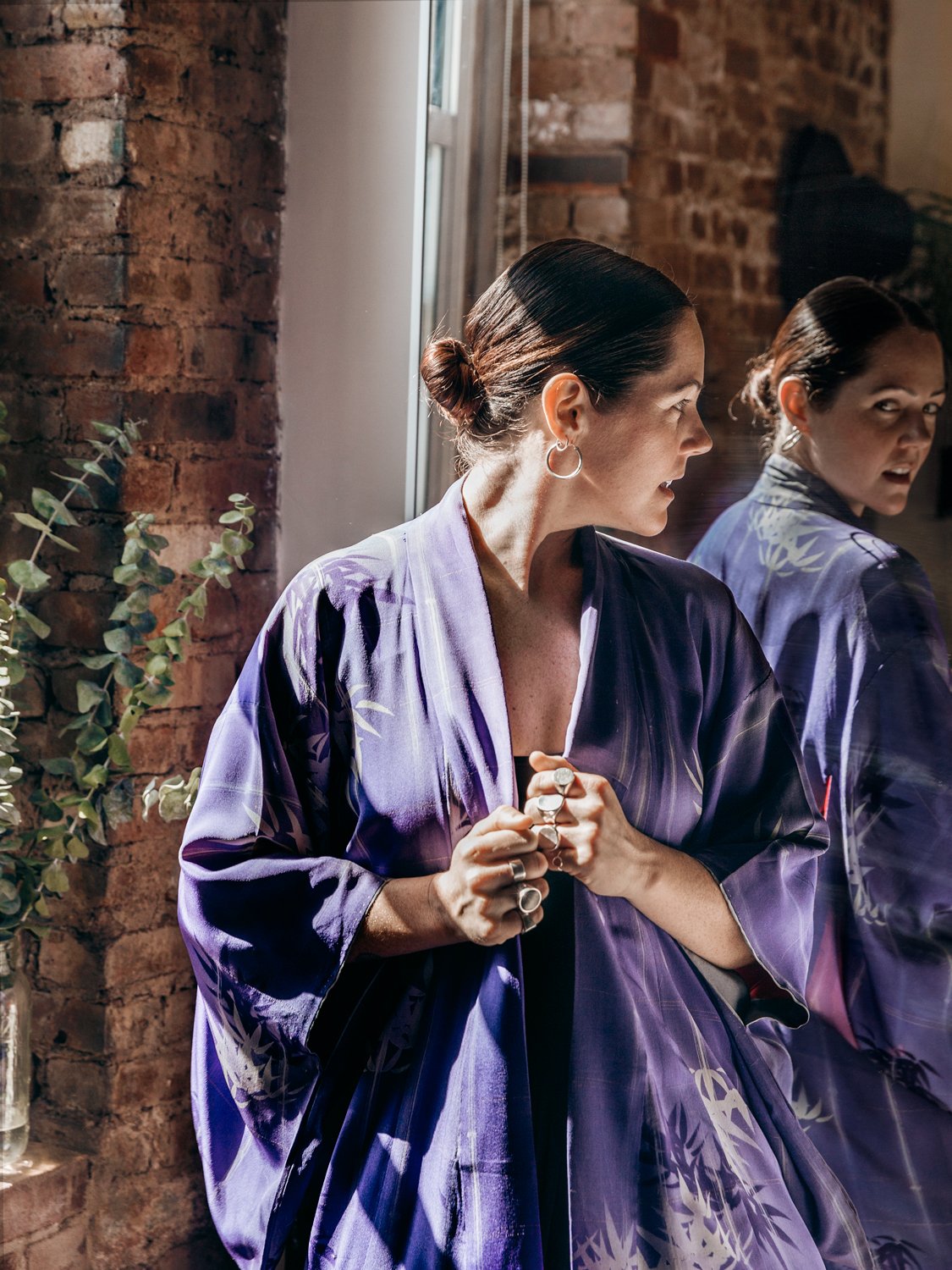 portrait of woman looking in mirror
