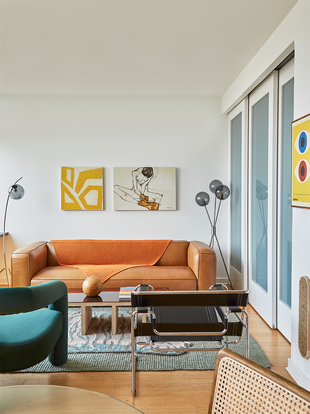 Living room with an orange sofa and teal chair