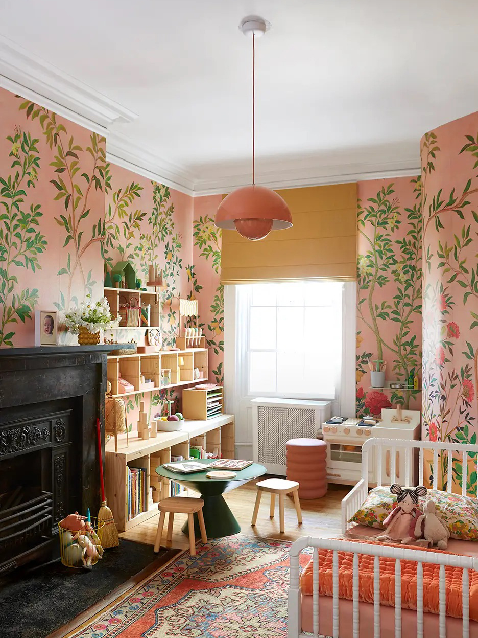 Little girl's room with pink botanical wallpaper and pink pendant lamp.