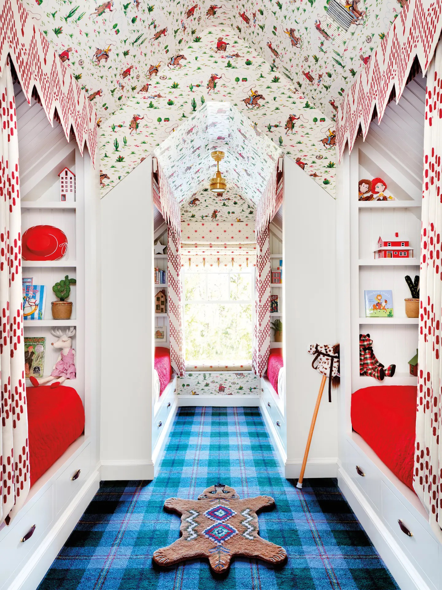 Kids' room covered in vintage cowboy-print wallpaper and blue tartan carpet.