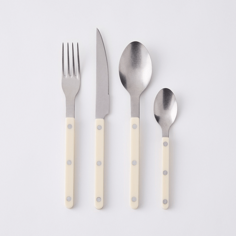  four pieces of sabre flatware with cream acrylic handles