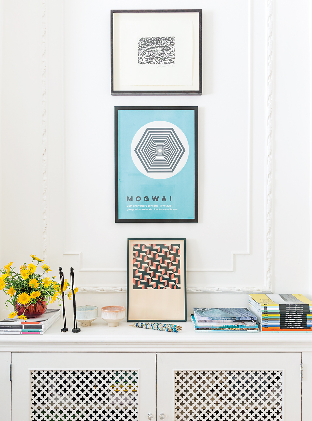 artwork above white cabinet