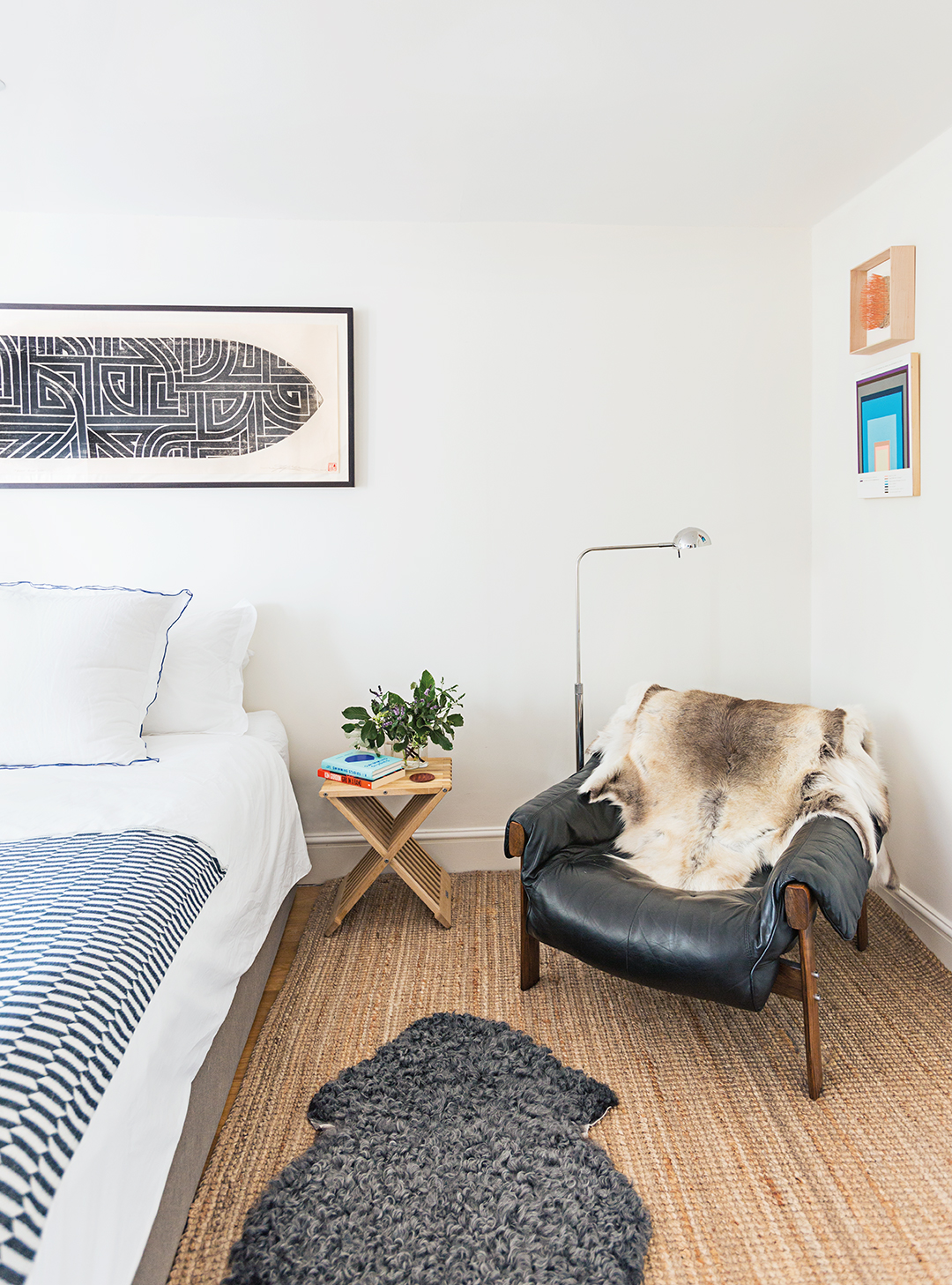neutral bedroom with sheepskin-covered armchair