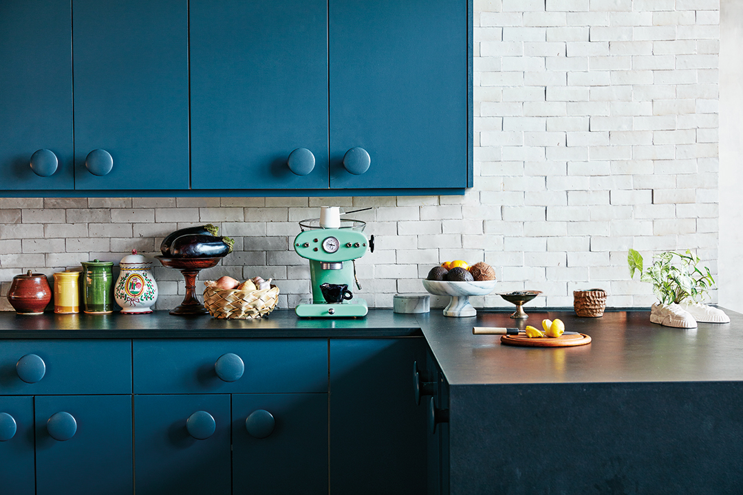 blue kitchen cabinets with oversized knobs