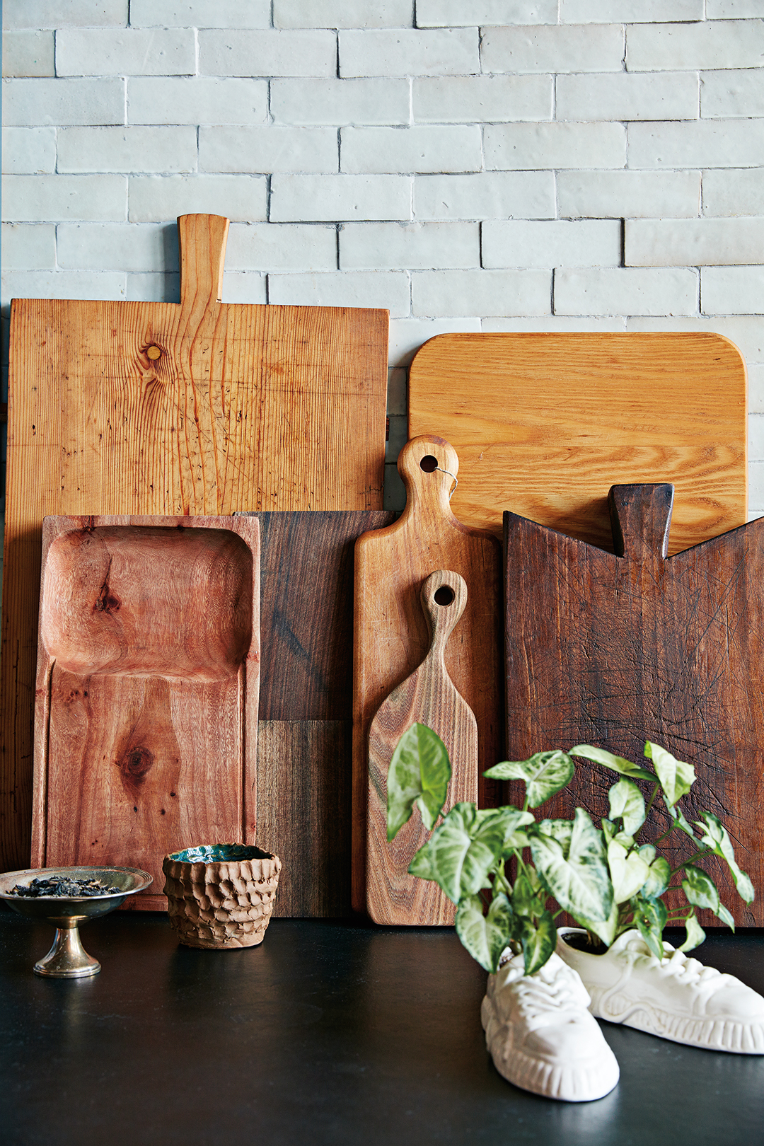wood cutting boards stacking against backsplash