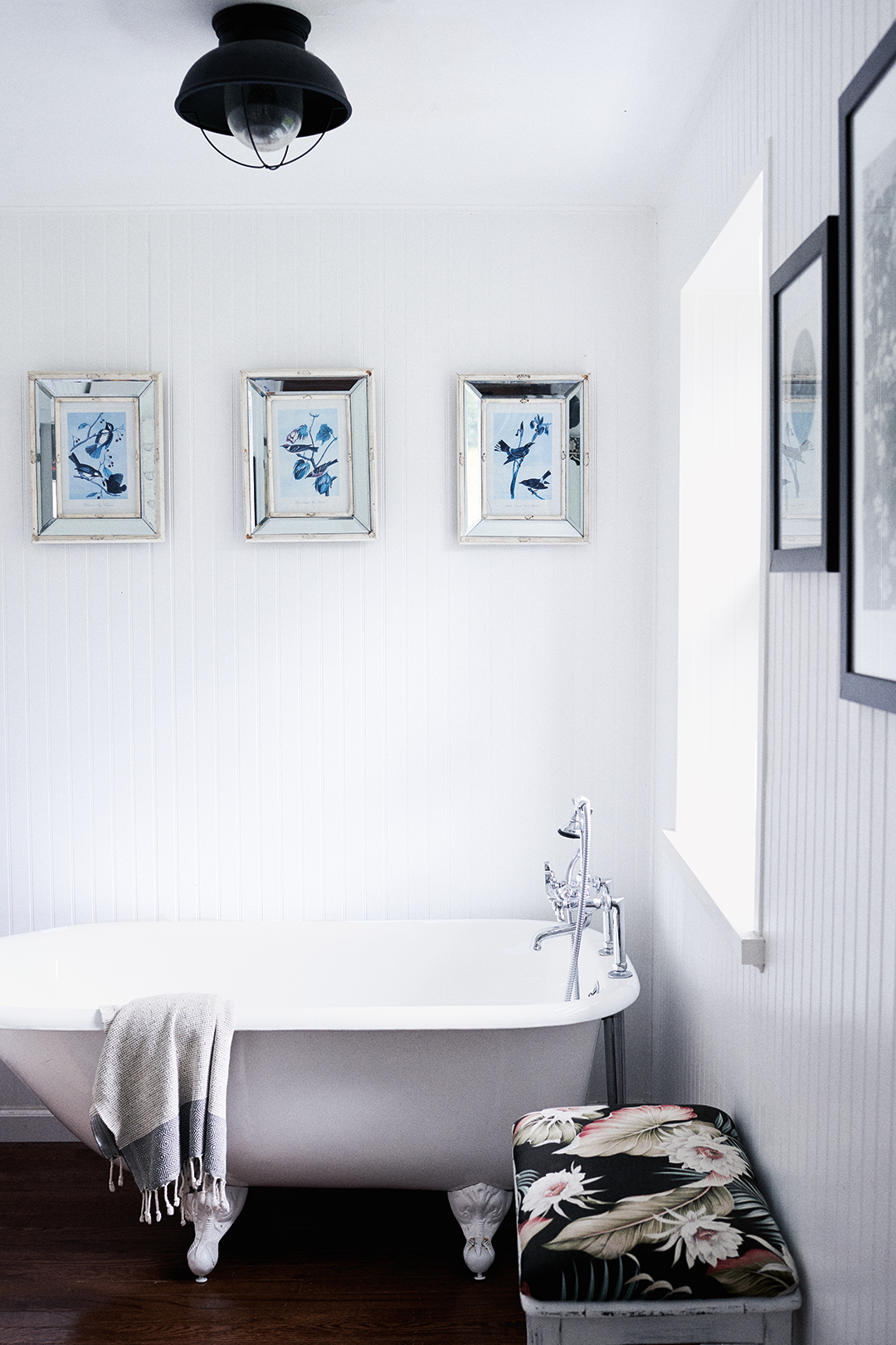 clawfoot tub in white farmhouse bathroom