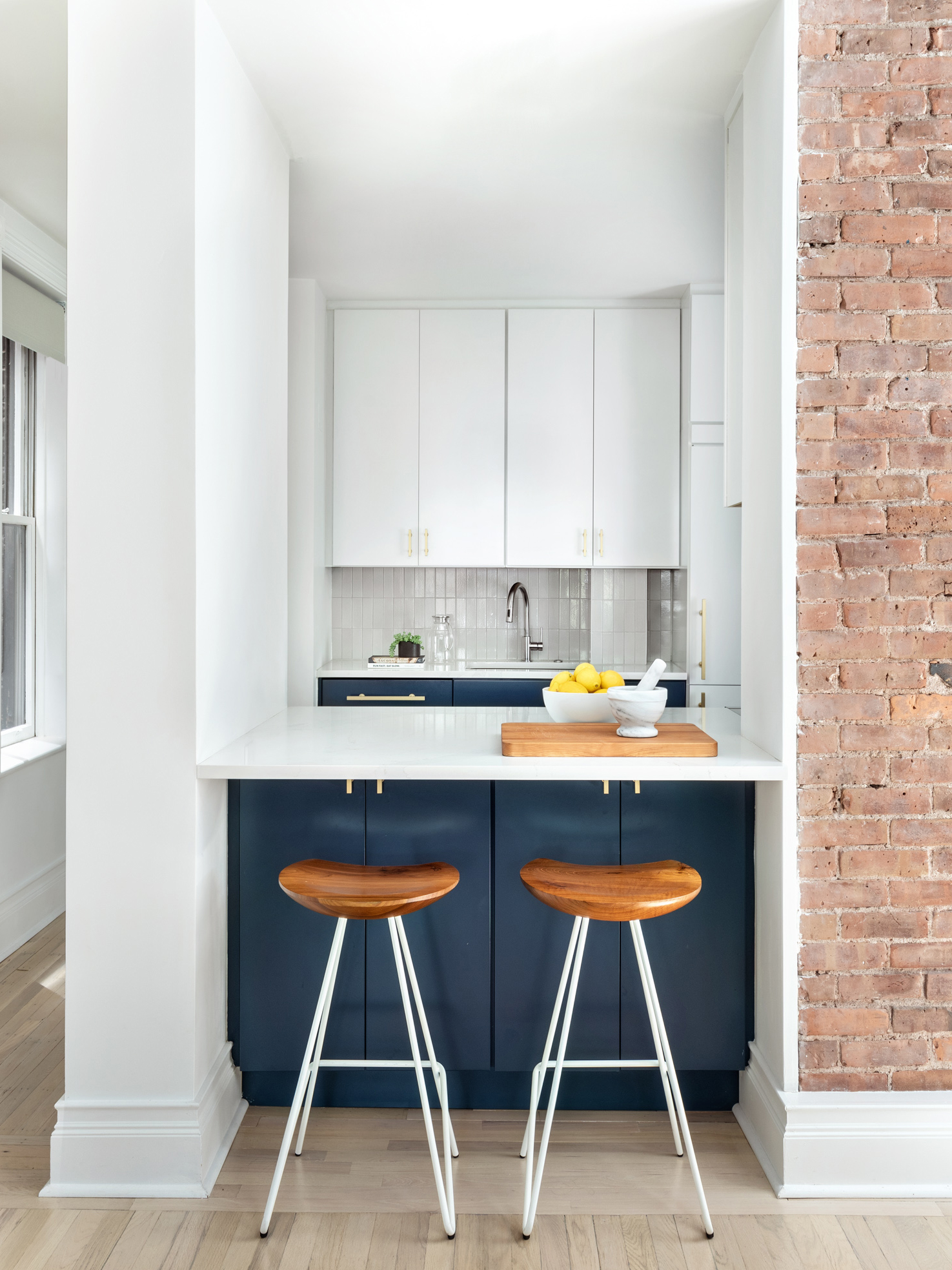 renovated kitchen with bar stools and kitchen counter