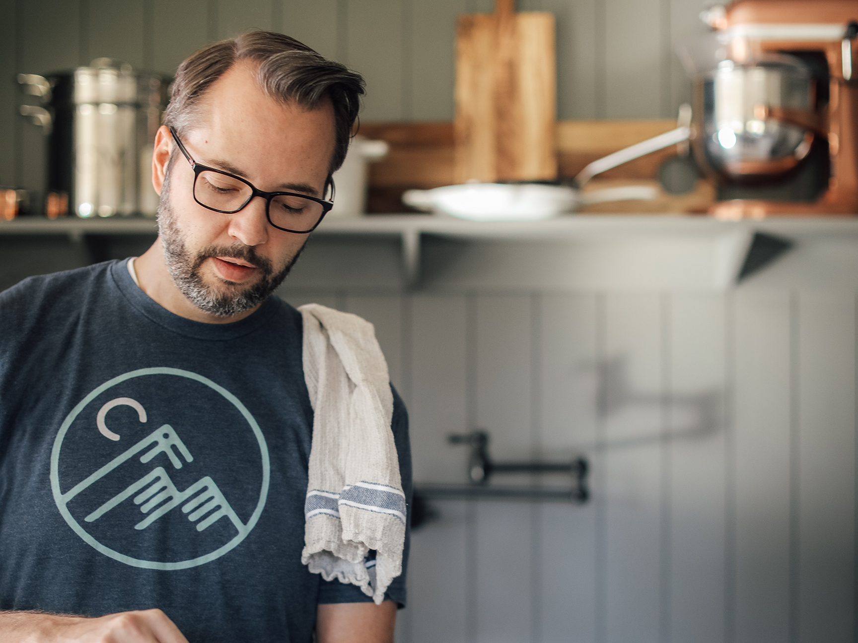 man cooking with a rag on his shoulder