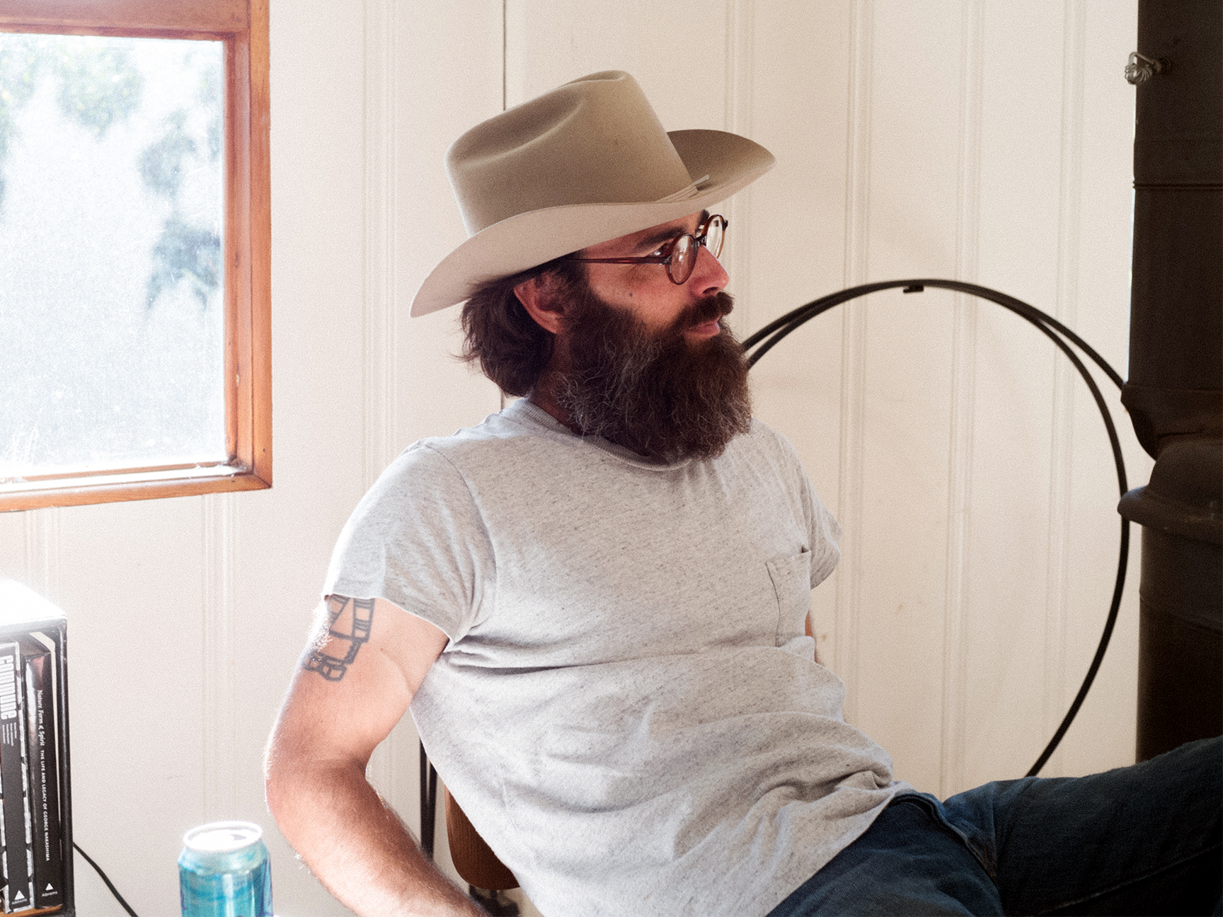 man with a hat sitting in a chair