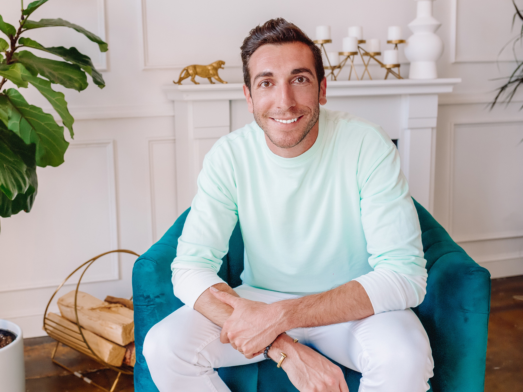 man in a mint green shirt smiling