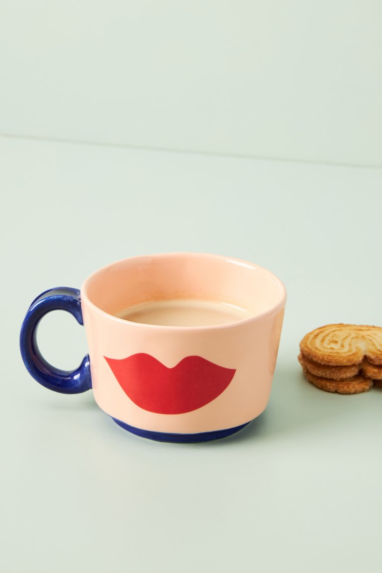  pink mug with red lip print on it