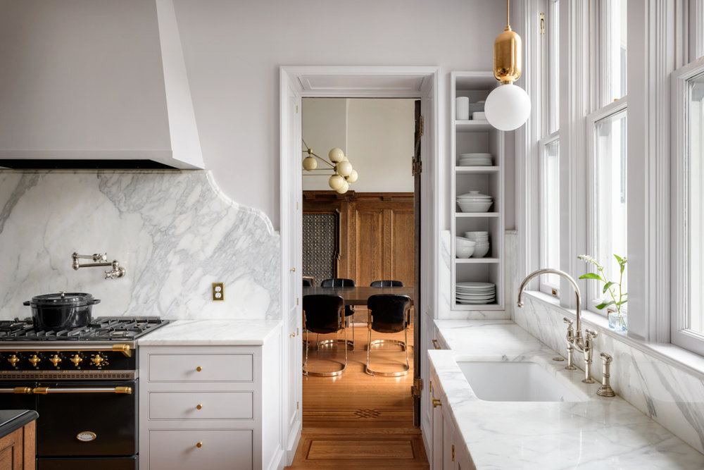 white kitchen with marble backsplash