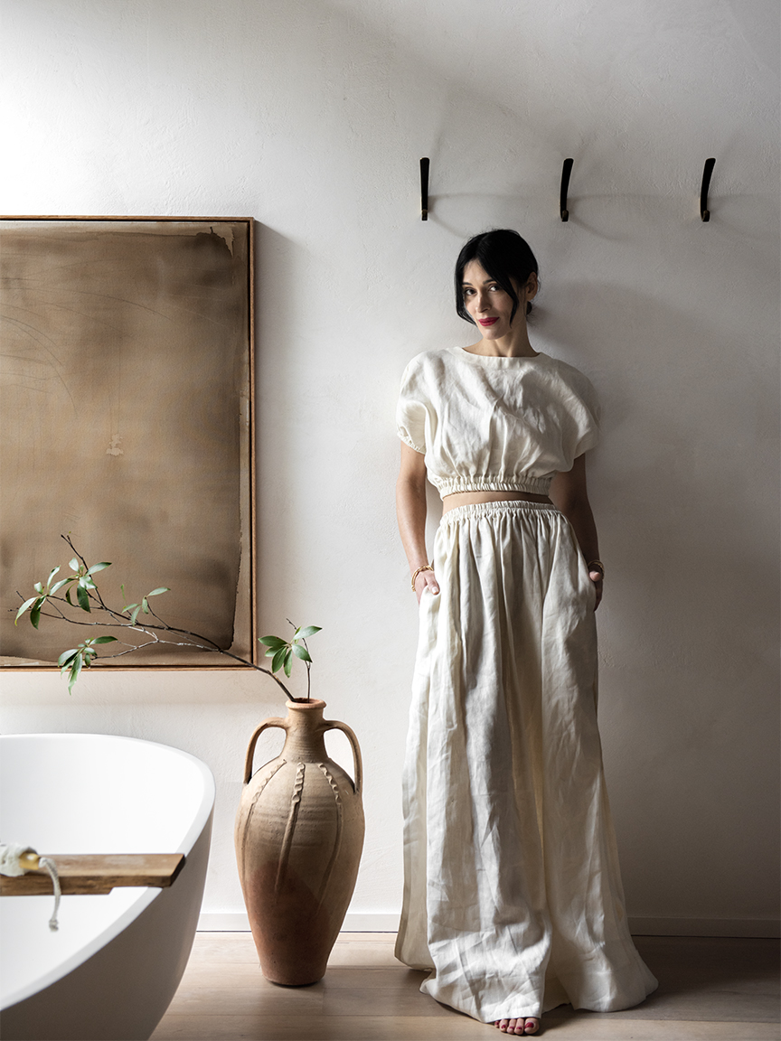 Athena calderone in bathroom next to white bath tub