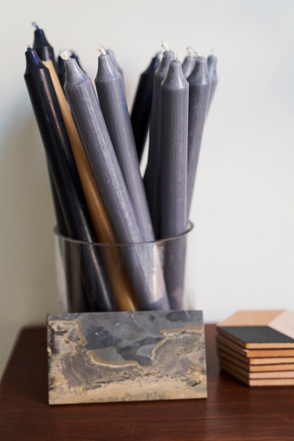 Taper candlesticks in a jar