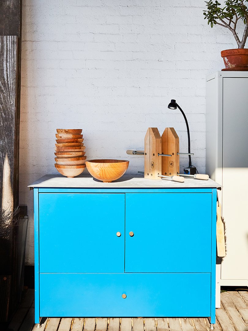 A blue cabinet decorated with ceramics