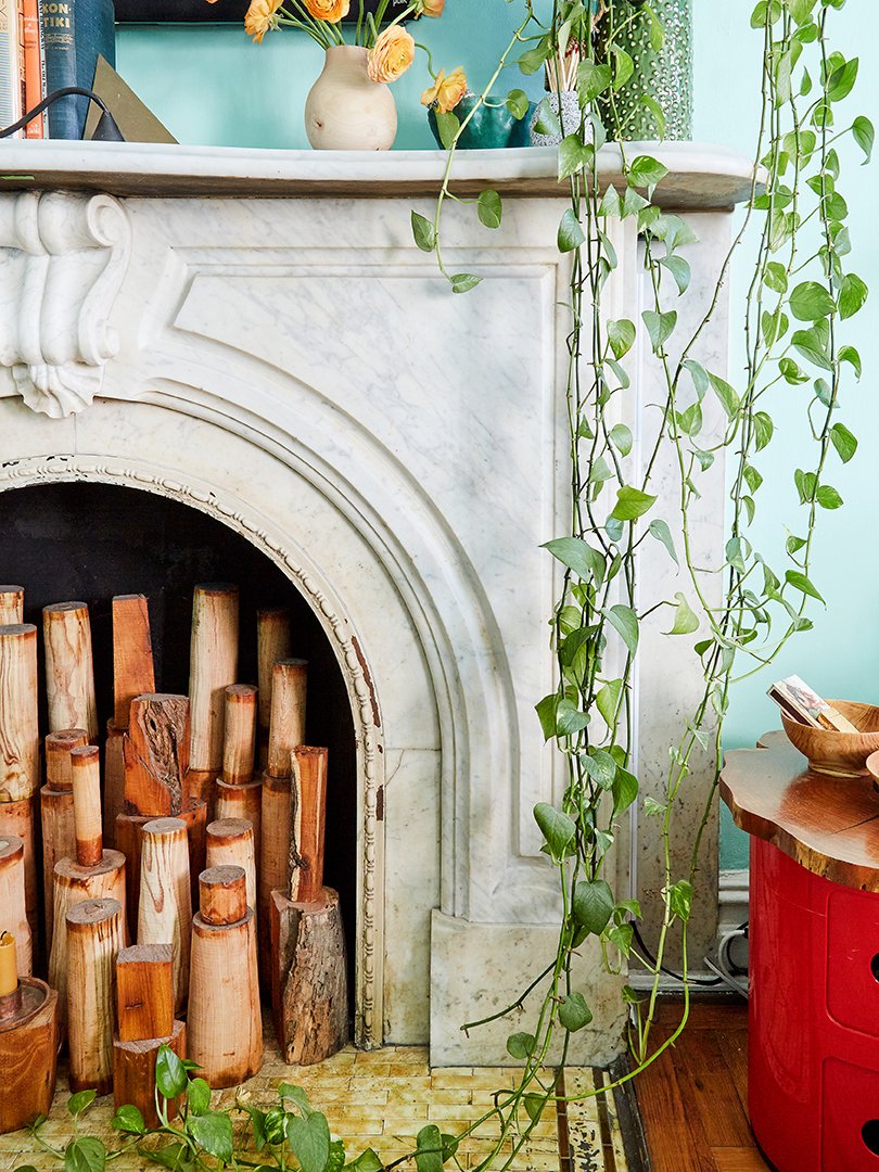 Decorative wood pillars fill the hearth a stone fireplace