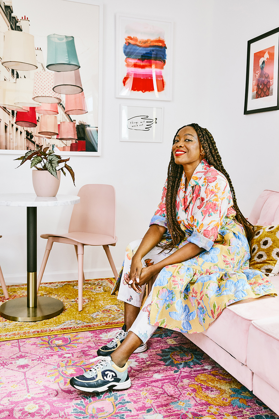 autumn adeigbo on pink sofa in office