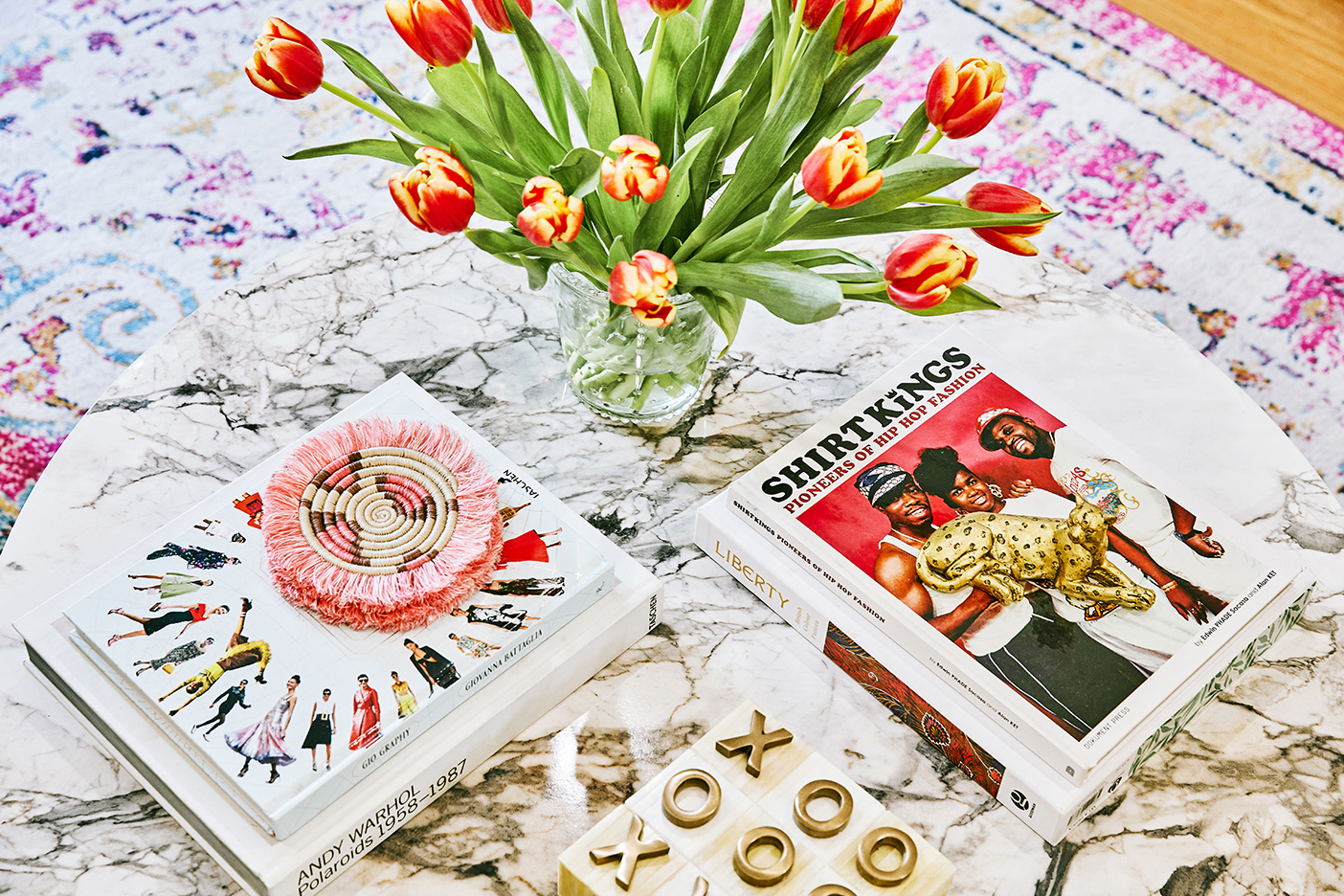 pink coasters and books on marble coffee table
