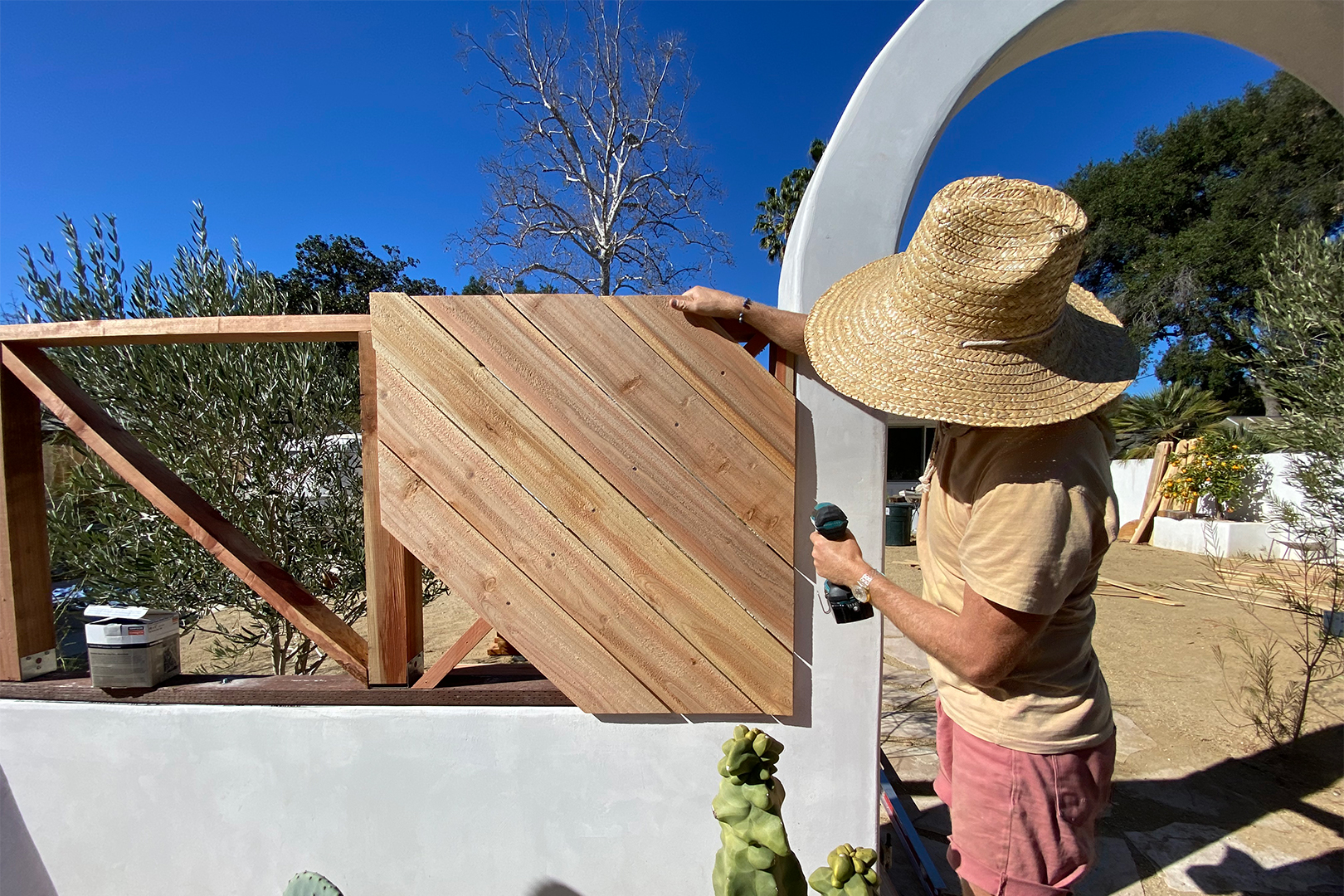 woman mounting fence wood
