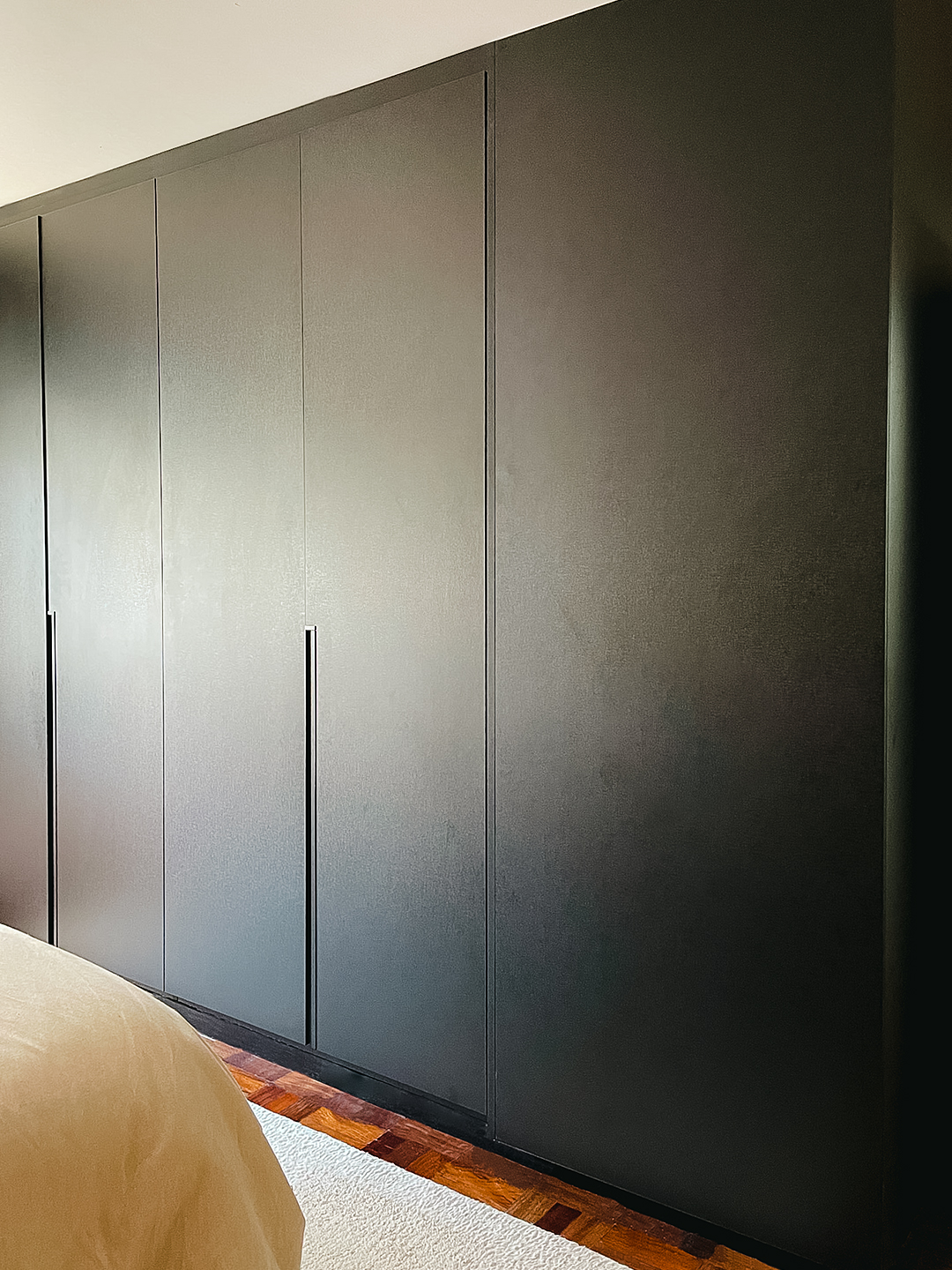 Wall of minimalist black built-in closets