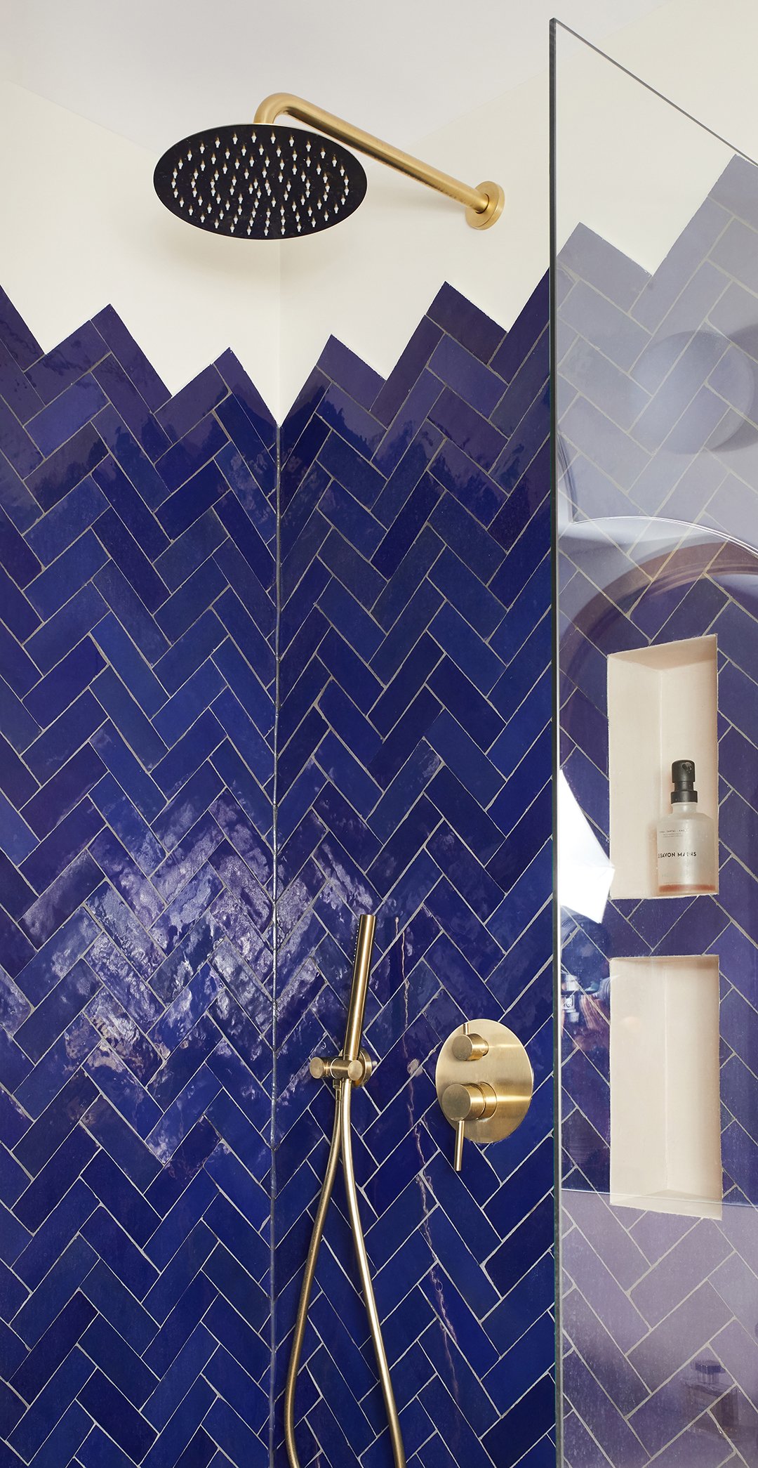 blue tiled shower with jagged edge