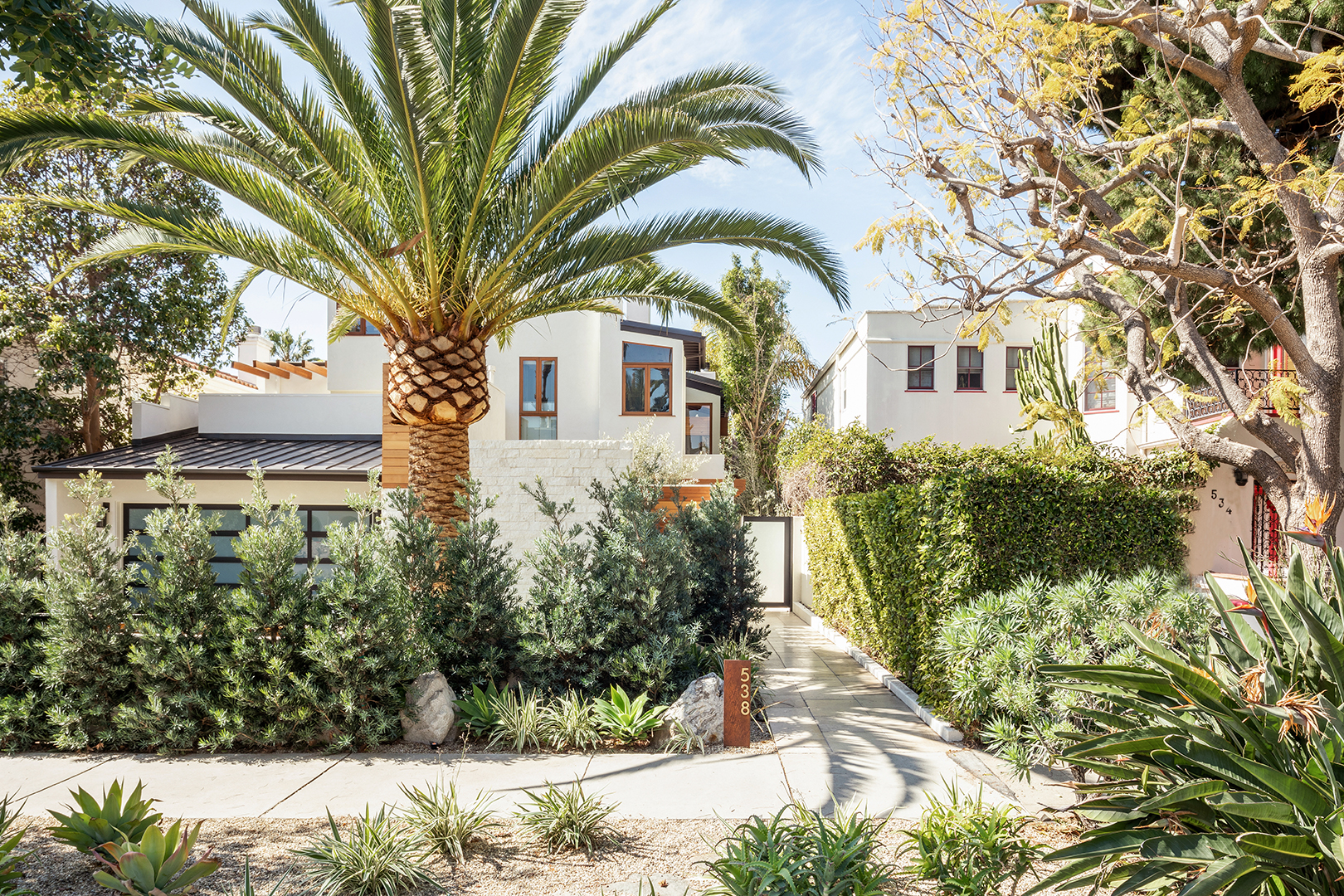 white home exterior with palm trees