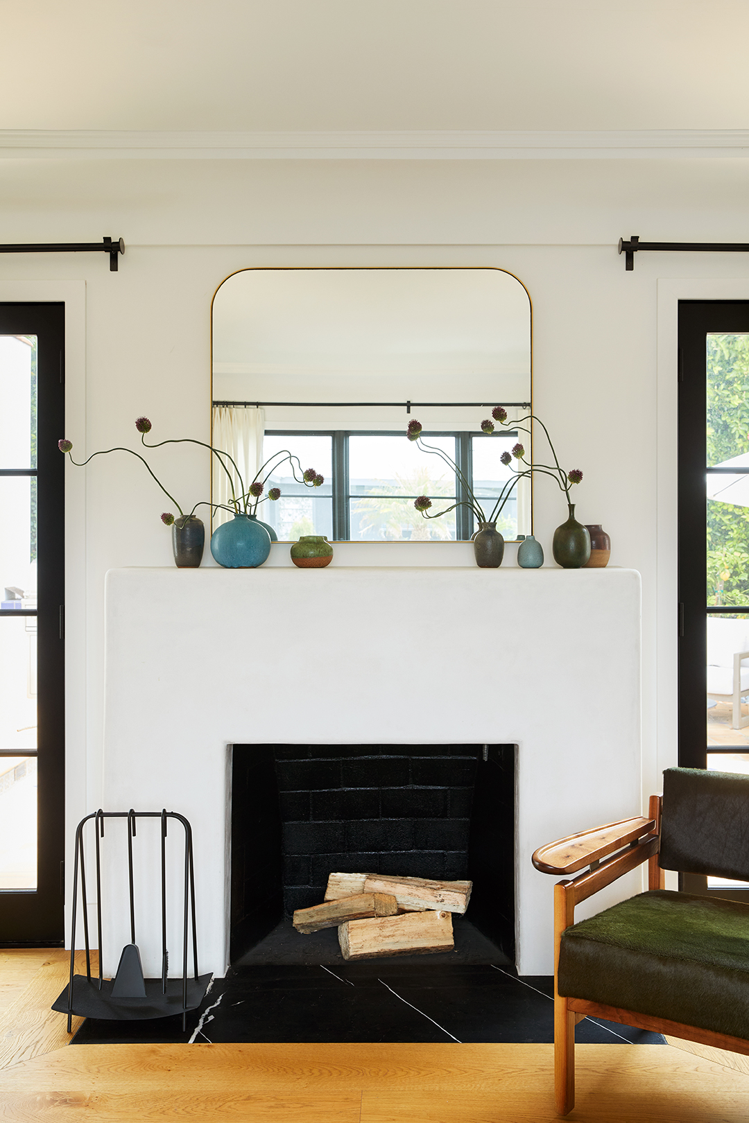 bud vases on top of fireplace