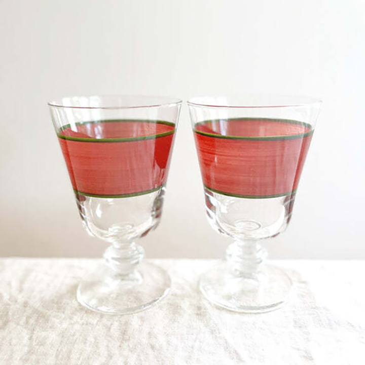  two glasses with red stripe.
