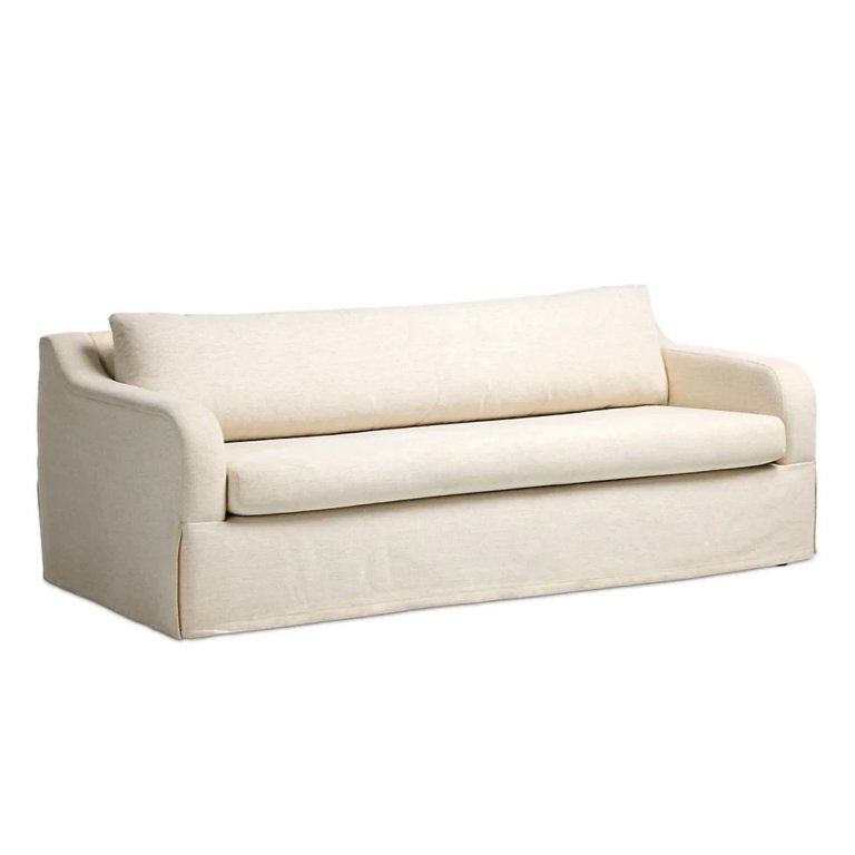 Sloped arm cream sofa on white background.