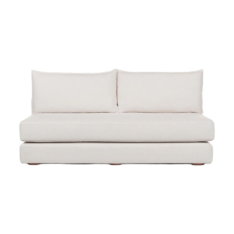Armless cream sofa on white background.