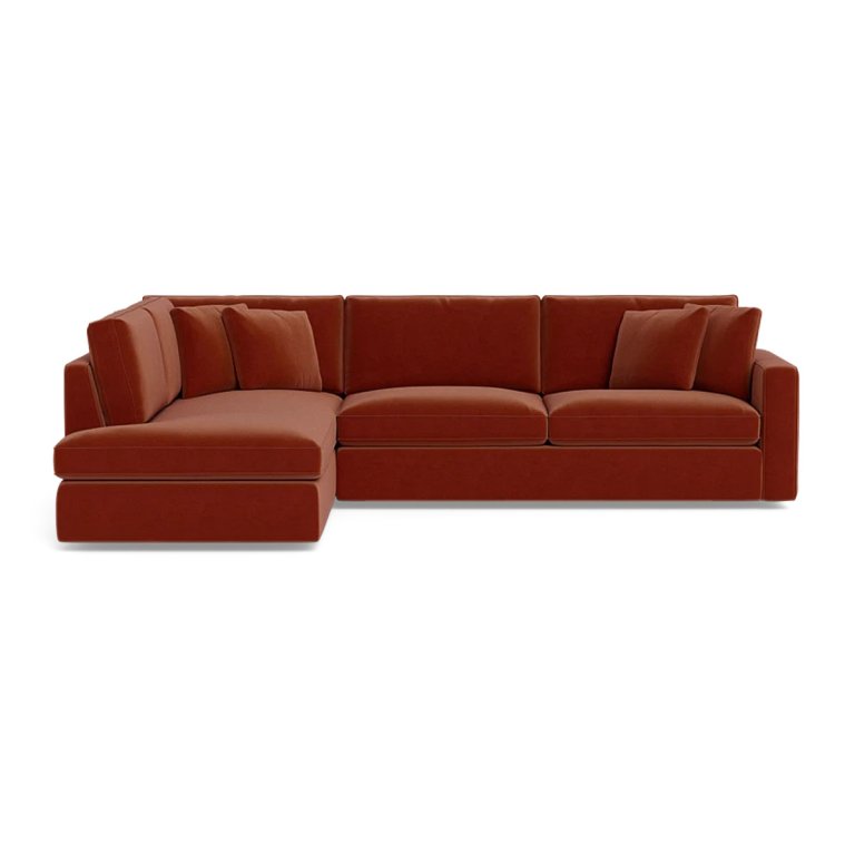 Rust-hued velvet sectional sleeper sofa on a white background.