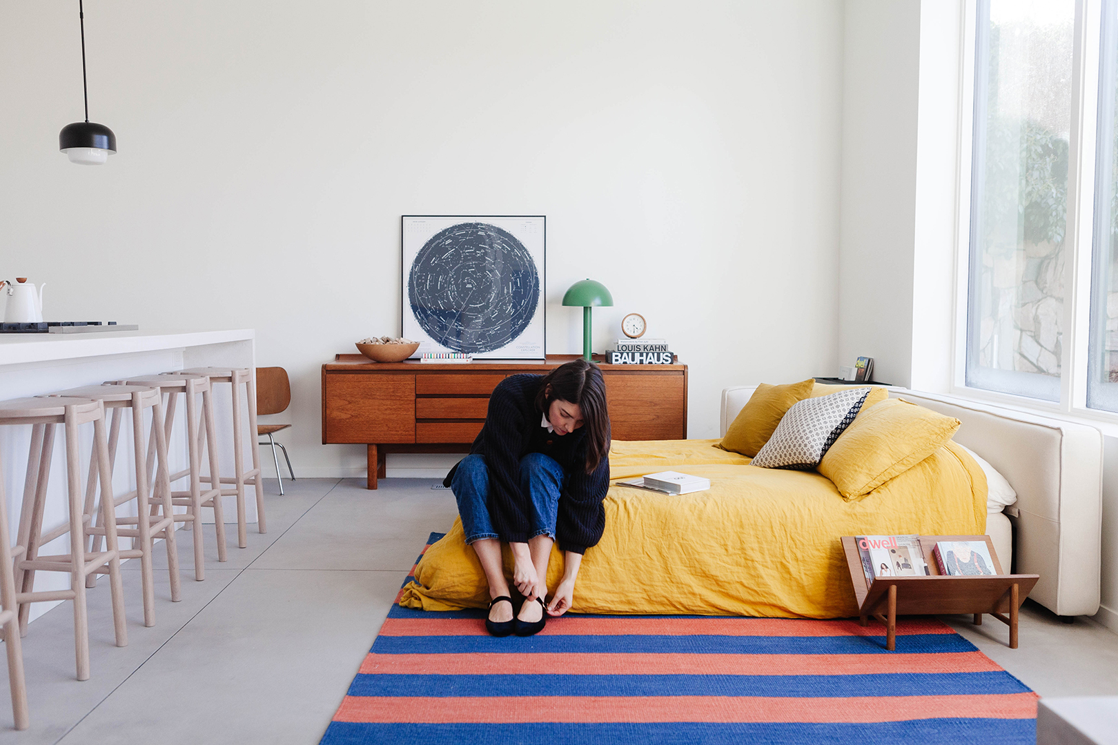 woman sitting on bed