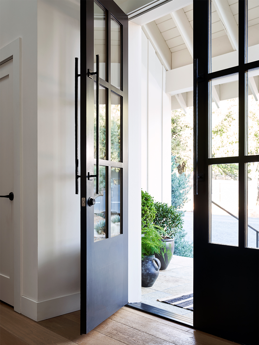 windowed black double doors with Level smart lock