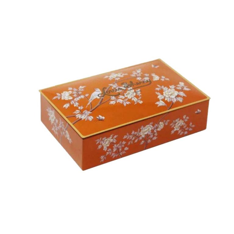 Orange tin with florals filled with truffles