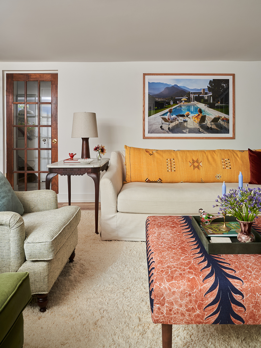 living room with pink ottoman