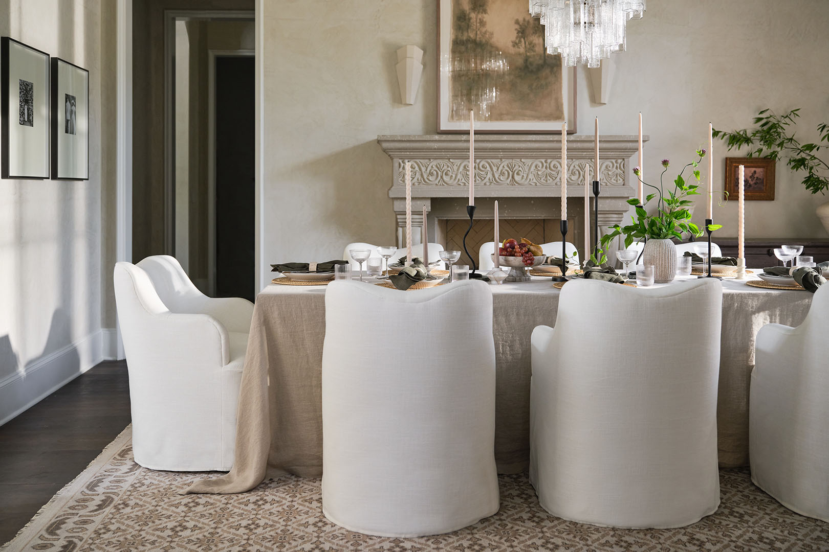 A dining room with white chairs and beige accents