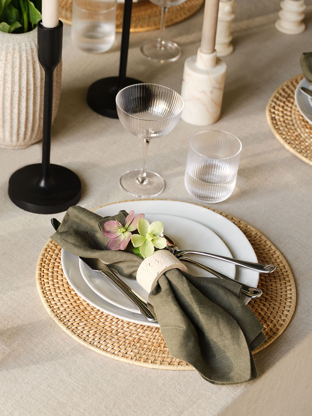 Table setting with white plates and moss green napkin