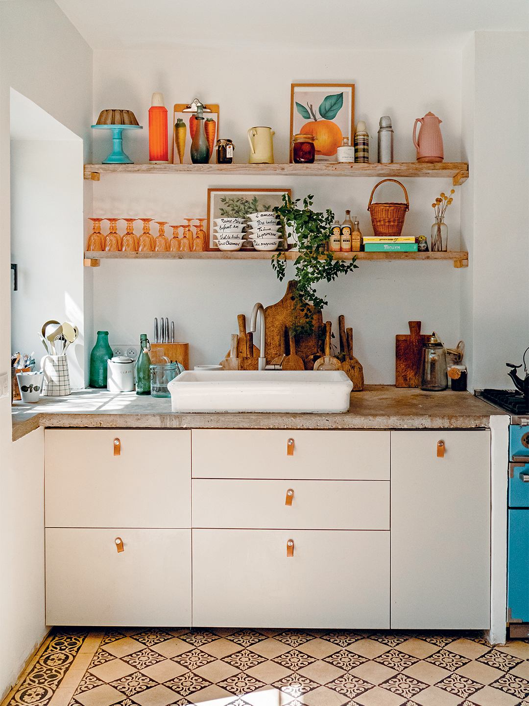 Kitchen with white cabinets and patterned tile