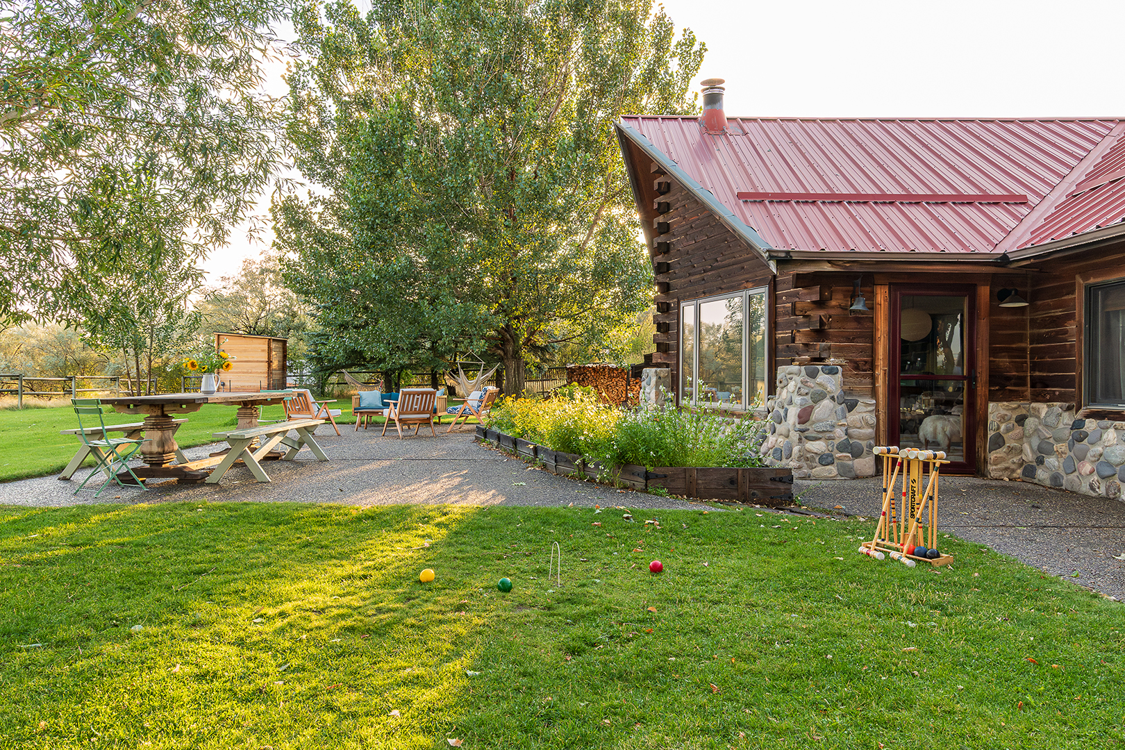 Log cabin exterior with sunny yard