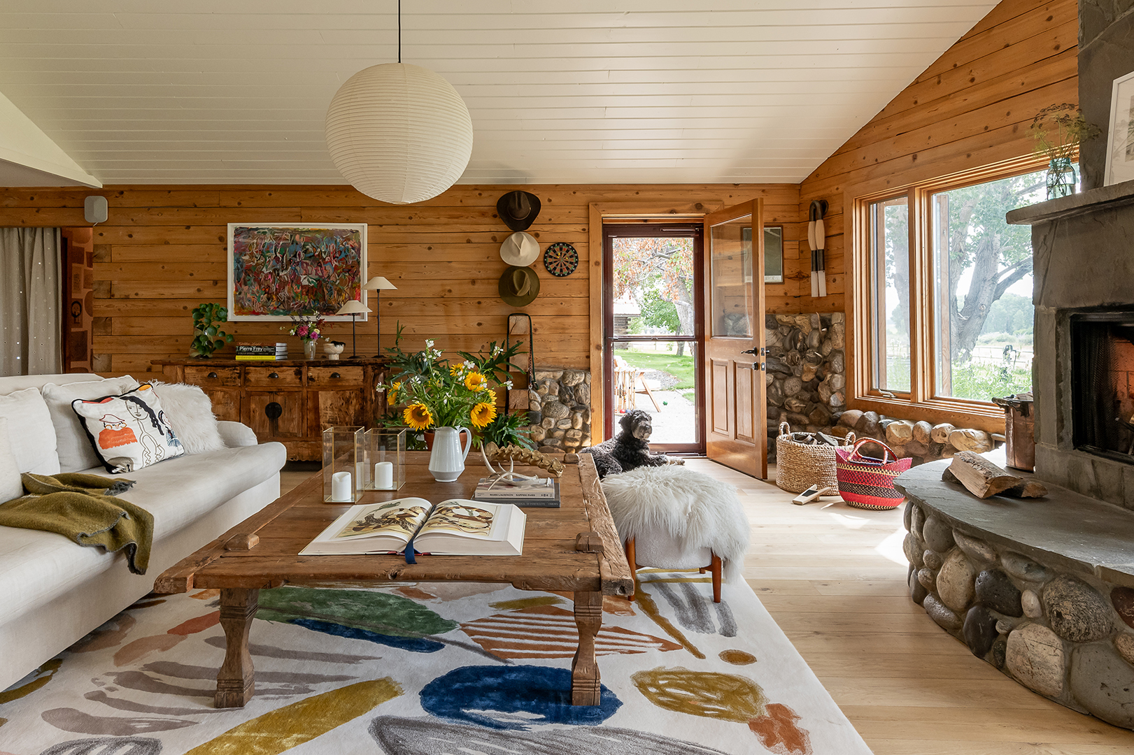 Living room with wood paneling and stone walls